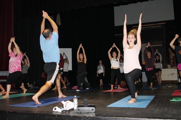 Physical education teacher Mr. John Sperry (left)  leads a group of GHS students in a yoga class.