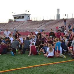 Coach Jeff Destino encourages track team after a hard loss