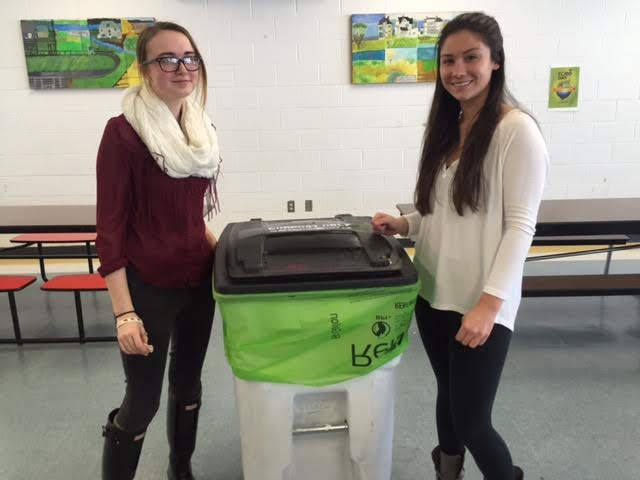 E-club members Gwen Koehne and Lauren Benchoff set up composting bins in the cafeteria
