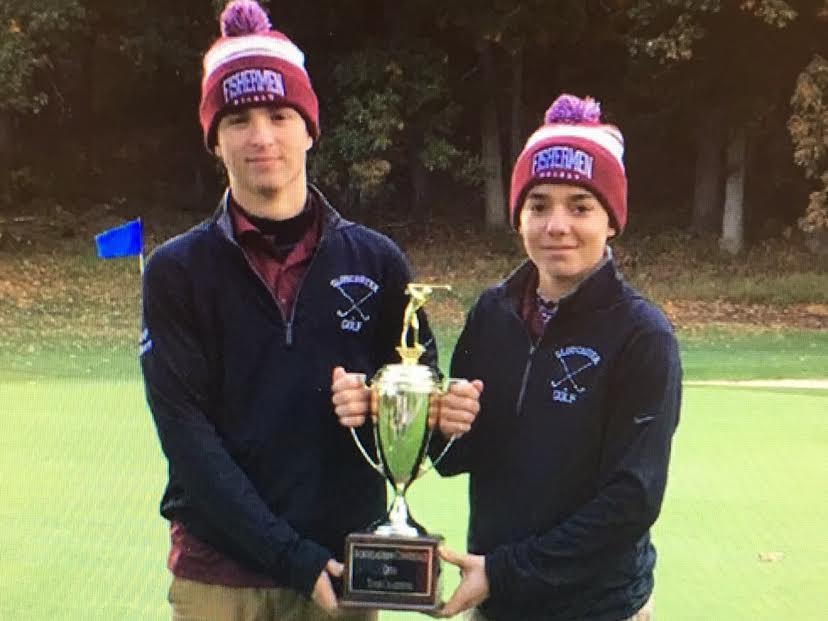 Robby Horne (left) and Colby Mitchell pose with their trophy at the 18th green