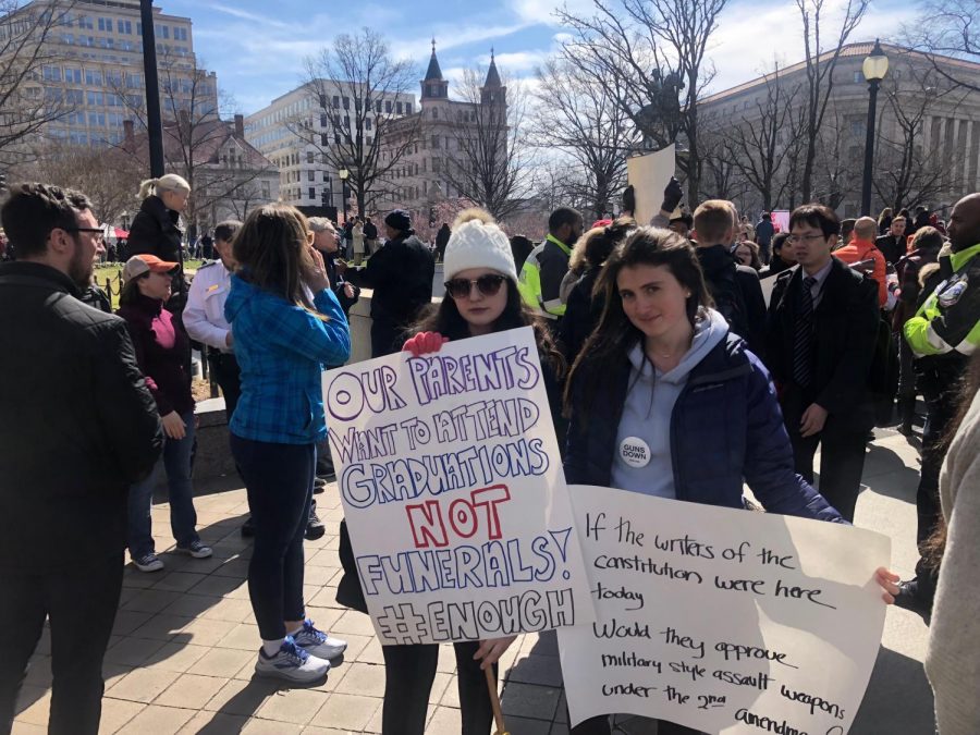 GHS students Maria Kotob and Sarah Whitmore hold homemade signs at the March for Our Lives in Washington D.C.