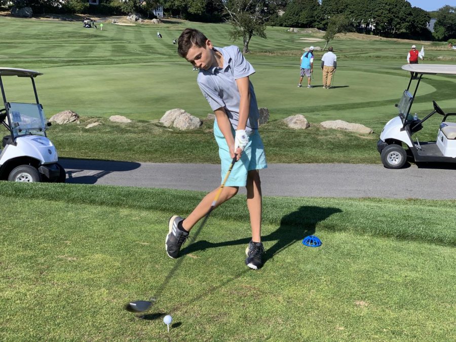 Freshman Michael Calamo drives the ball on the first hole at Bass Rocks Golf Club