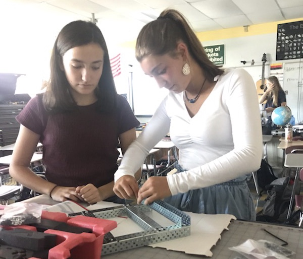 Sophomores Jenna Smith and Sophia Costa work on a Vex 5 Clawbot in E block  Robotics class