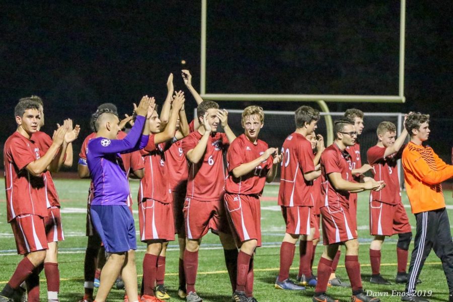 Boys soccer team celebrates after a win. 