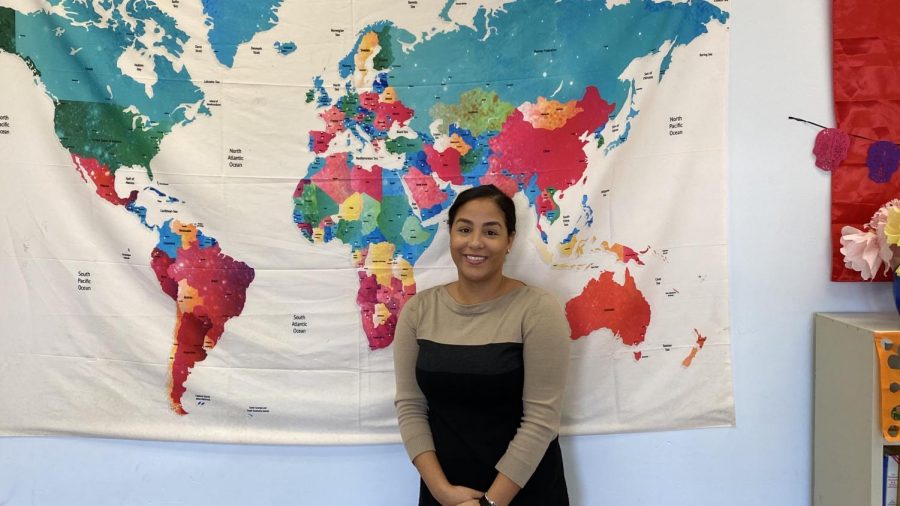 GHS new Spanish teacher, Señorita Robles, poses by the map in her new classroom