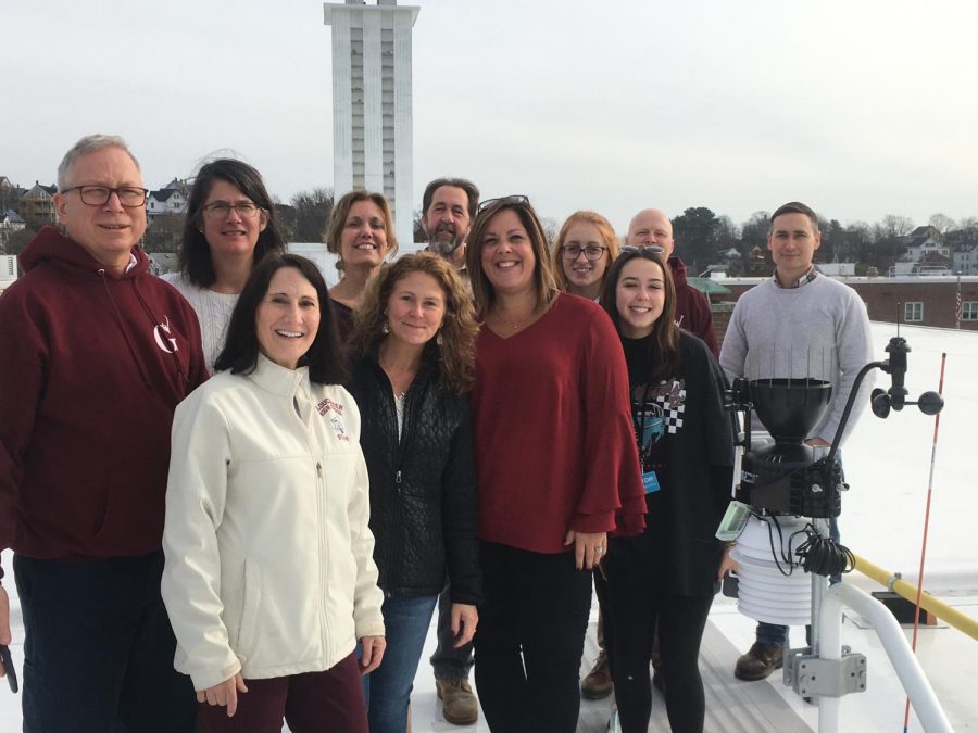 Members of the science department on the roof with their new weather station