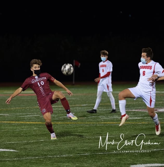 Junior Andrew Coelho controls the ball as defenders approach