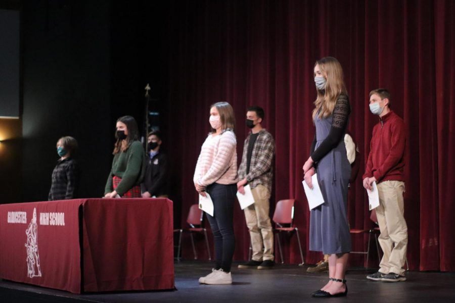 Students stand masked and socially distanced as they accept their Sawyer Medal awards