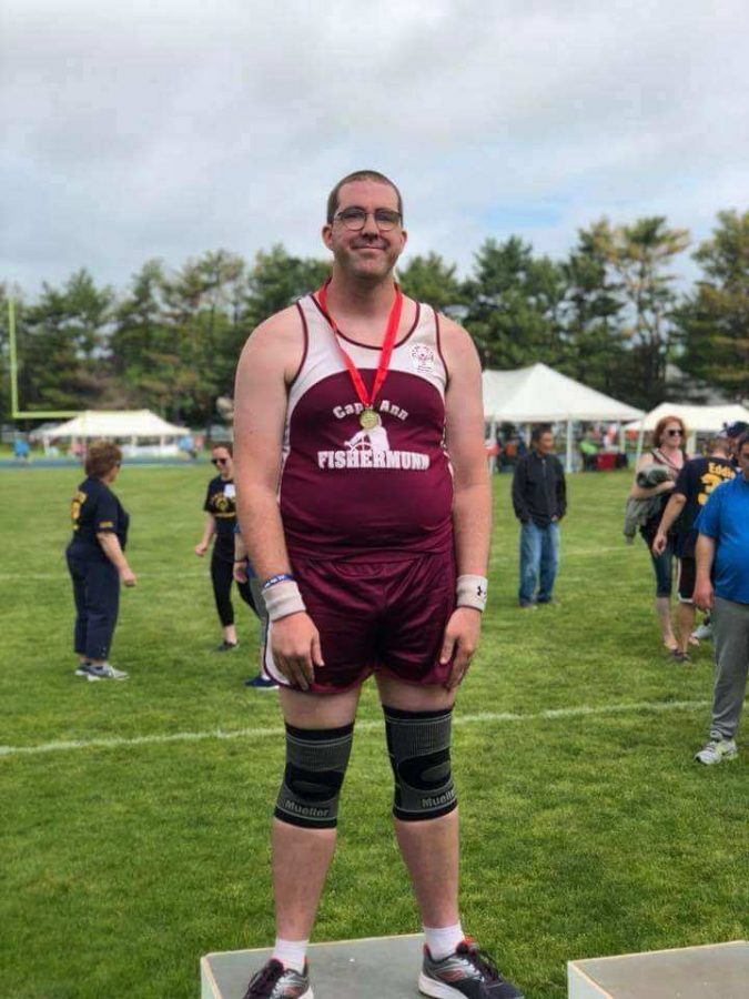 Danny Williamson receiving a gold medal for shot put at the Special Olympics