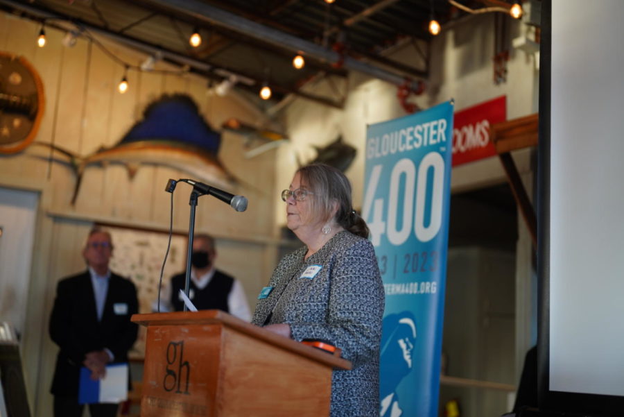 Linn Parisi welcomes guests to the Gloucester 400 event at the Blue Collar Cafe
