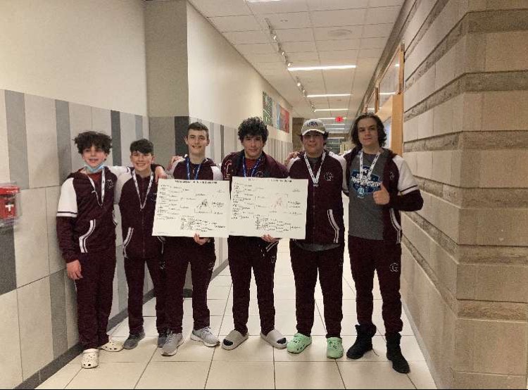 Gloucesters two sectional champions Daniel Beaton and Michael Toppan pose with members of the wrestling team. 