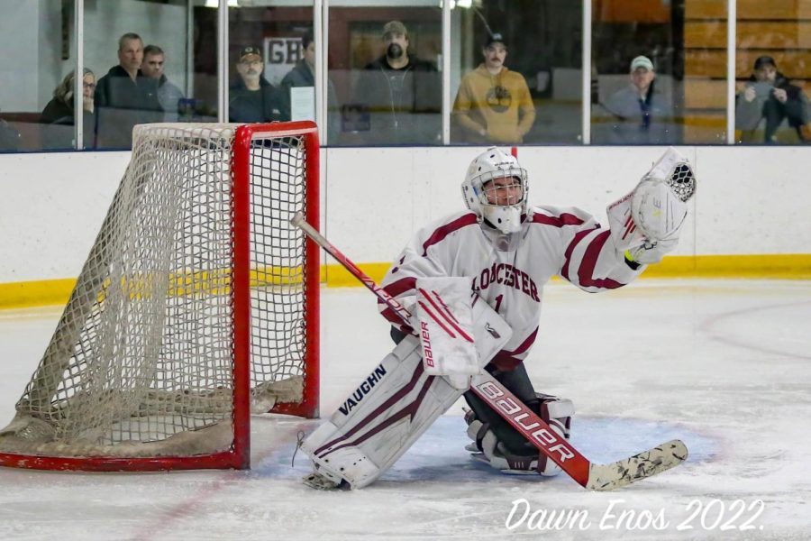 Gloucester Goalie Nick Tarantino catches a flying puck from his left corner.