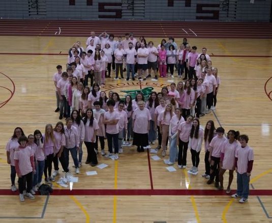 GHS students and staff pose for a picture in the shape of a ribbon.