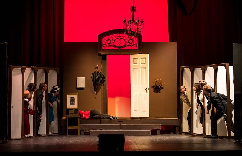 The cast of Clue utilizes the 8 doors in the set designed by Tyler Weed.