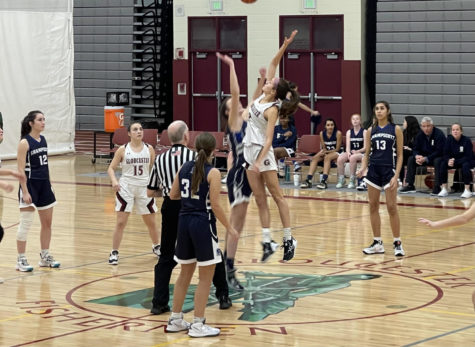 Junior Abby Stauffer takes the jump ball to start the game. 