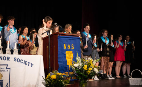 NHS class of 2023 secretary, Eliana Cracchiolo, leads new inductees in the NHS pledge.