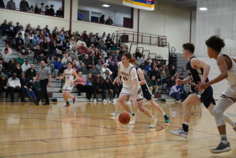 Nate Montagnino drives down the court for a transition layup against Essex Tech