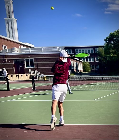 Domenic Paone serves the ball over the net. 