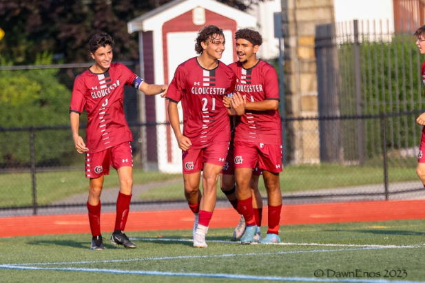(from left) Domenic Paone, Gino Tripoli, and Andrew Fahim celebrate an early game goal.
