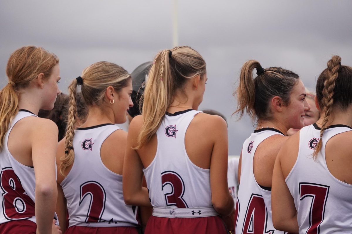 (From Left): Isla Black, Bella Goulart, Lexi Carollo, Lily Pregent, and Anna Cinelli huddle up pre-game 