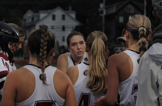 Captain Ella Costa (center) speaks with her team in a huddle