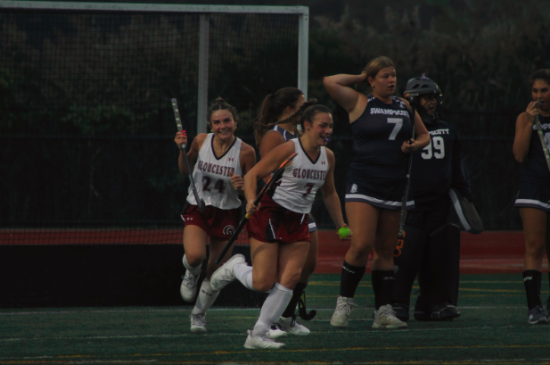 Lily Pregent (left) and Anna Cinelli (right) smile after a Gloucester goal 