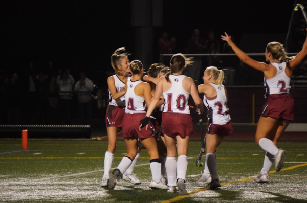 The field hockey forwards/midfielders celebrate their third goal during the 2nd round playoff game 