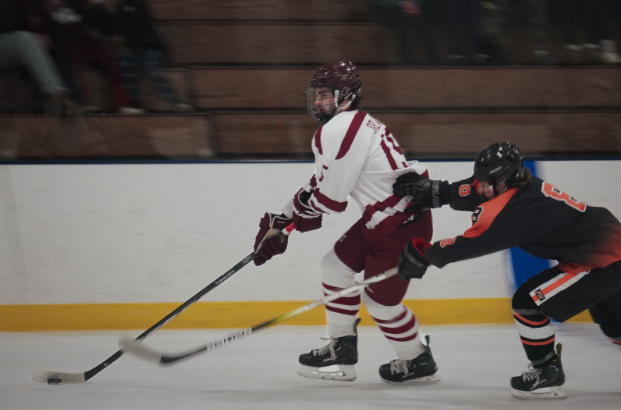 Joe Orlando skates across the ice away from his Beverly opponent 