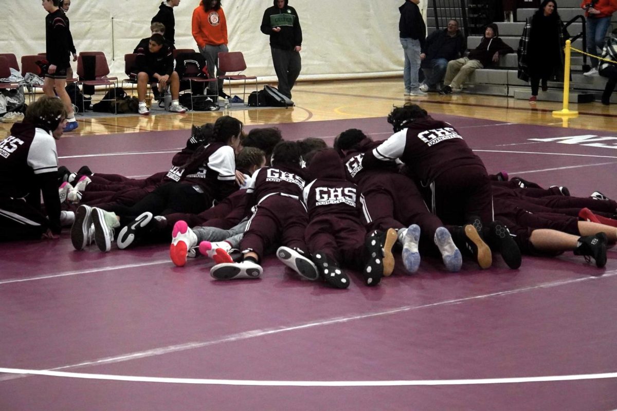 GHS Wrestling huddles before the first match