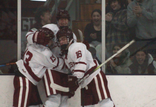 Kellen Moran (center) celebrates with his teammates Peter Gilraine (left) and Charlie Terelak (right) after scoring his first varsity goal for Gloucester