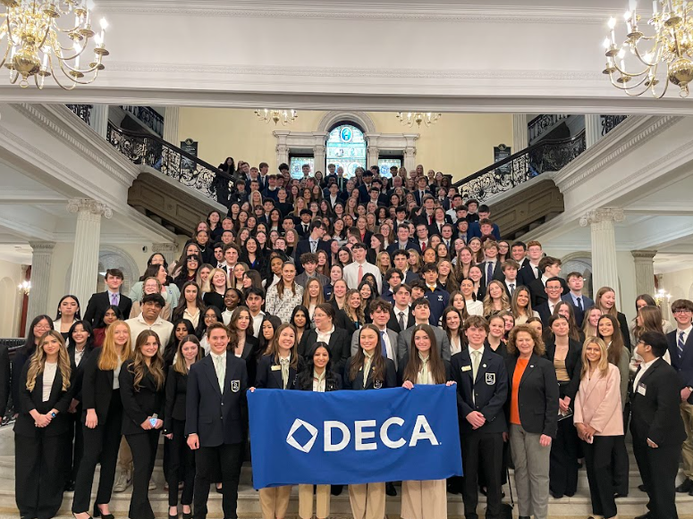 Massachusetts DECA chapters stand on the statehouse staircase.