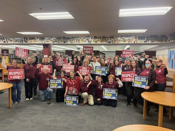 Gloucester educators hold up signs in support of paid parental  and family leave. Photo credit: Gloucester Teachers Association 