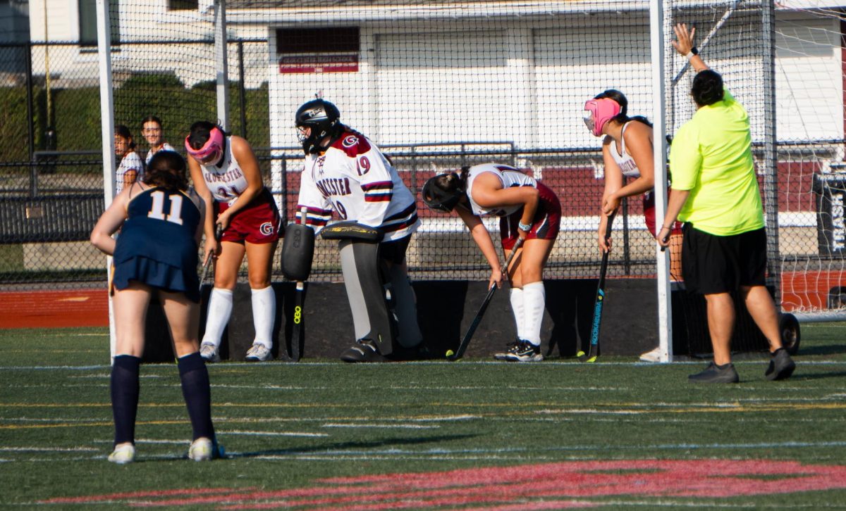 Gloucester defenders line up inside the net for a penalty corner.