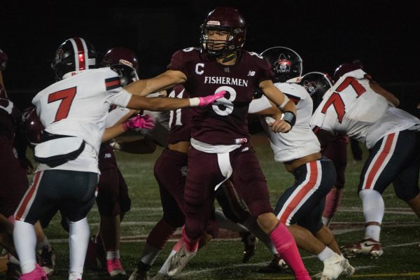 Captain Jaylen Severino pushes through a defensive line of Salem Witches in last Friday's Newell Stadium matchup.