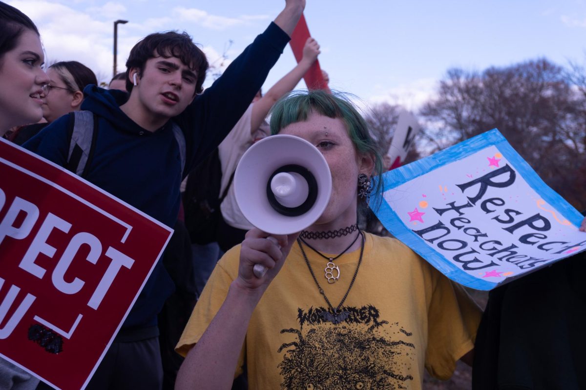 Student Keith Kershaw addresses the crowd via megaphone. 