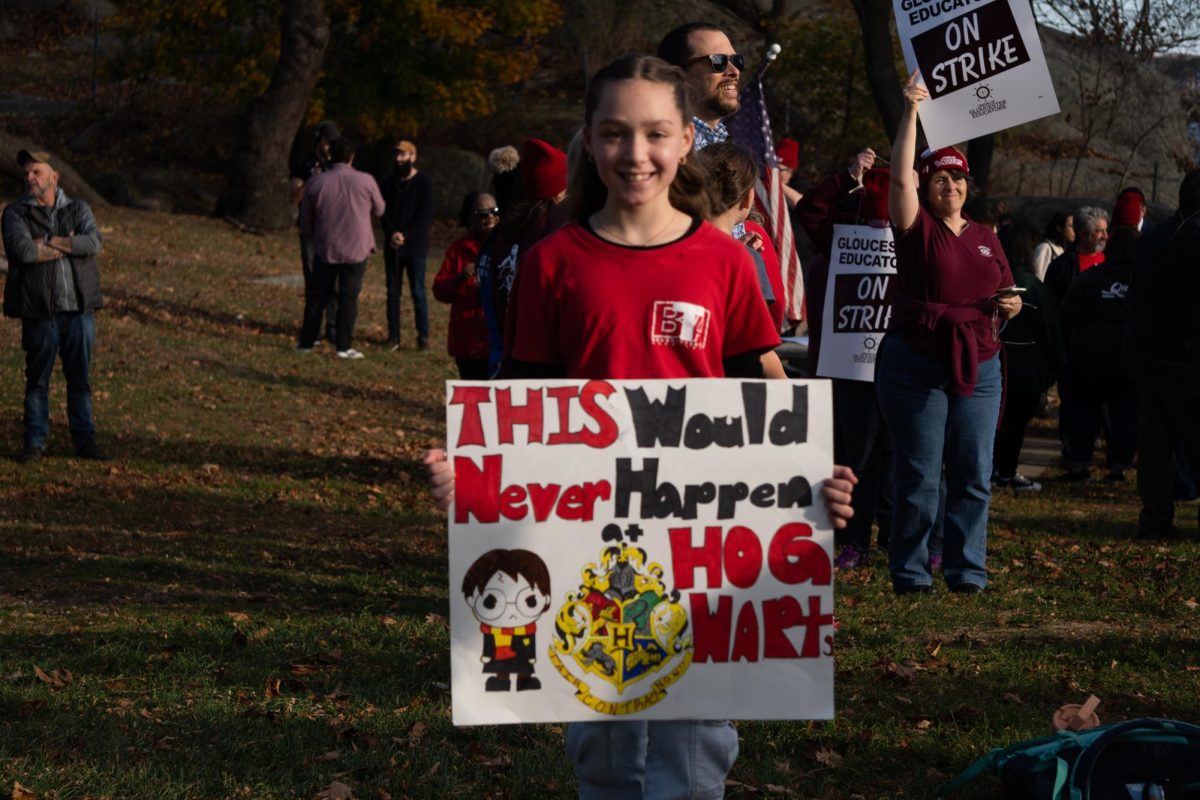 Beverly student Grace poses with her Harry Potter inspired sign at the rally.