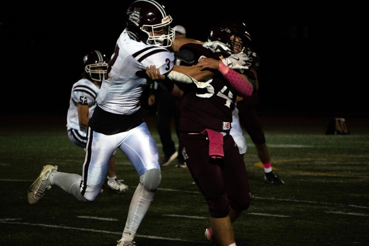 Thomas Cribbs is grabbed by a Falmouth defender in last Friday's win against the Clippers.