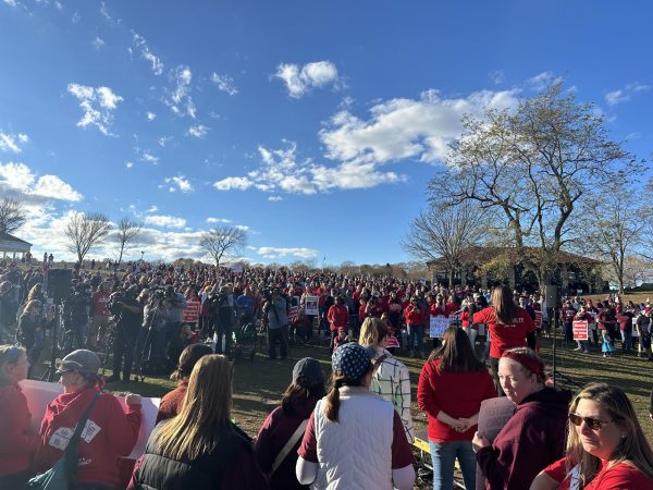 A large crowd of educators and community members from around Massachusetts gather at the Stage Fort Park. 