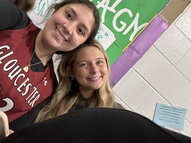 Seniors Olivia Testeverde and Ivana Ferrara take a selfie in front of the GHS Mental Health bulletin board. 