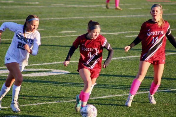 Skye Colino dribbles the ball along the sideline.