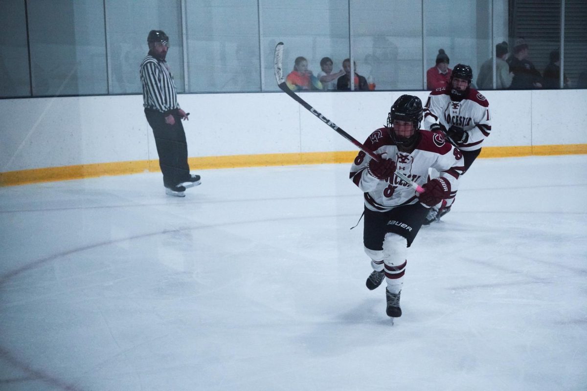 Freshman Kaya Collins skates down the ice in front of junior captain Keagan Jewell.