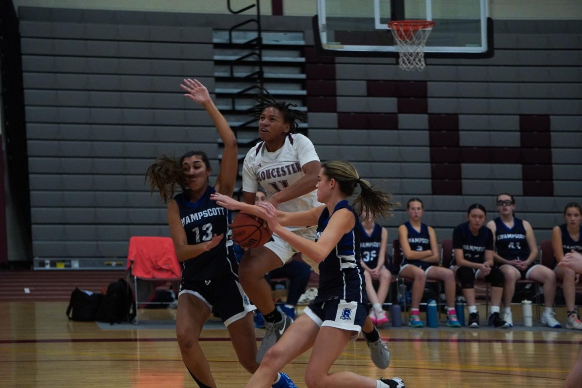 Junior Jordan Perdue-DelTorchio tries to shoot through two Swampscott defenders. 