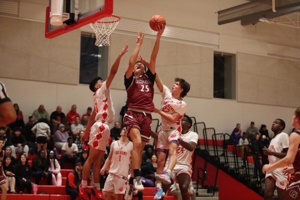 Senior Charlie Amero goes up for a layup over saugus defender. 