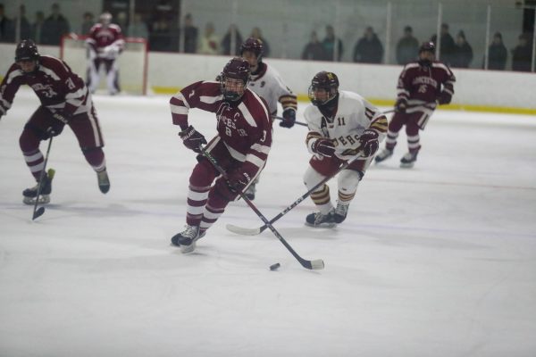 Senior Captain Colby Warren out skates Newburyport defender. 