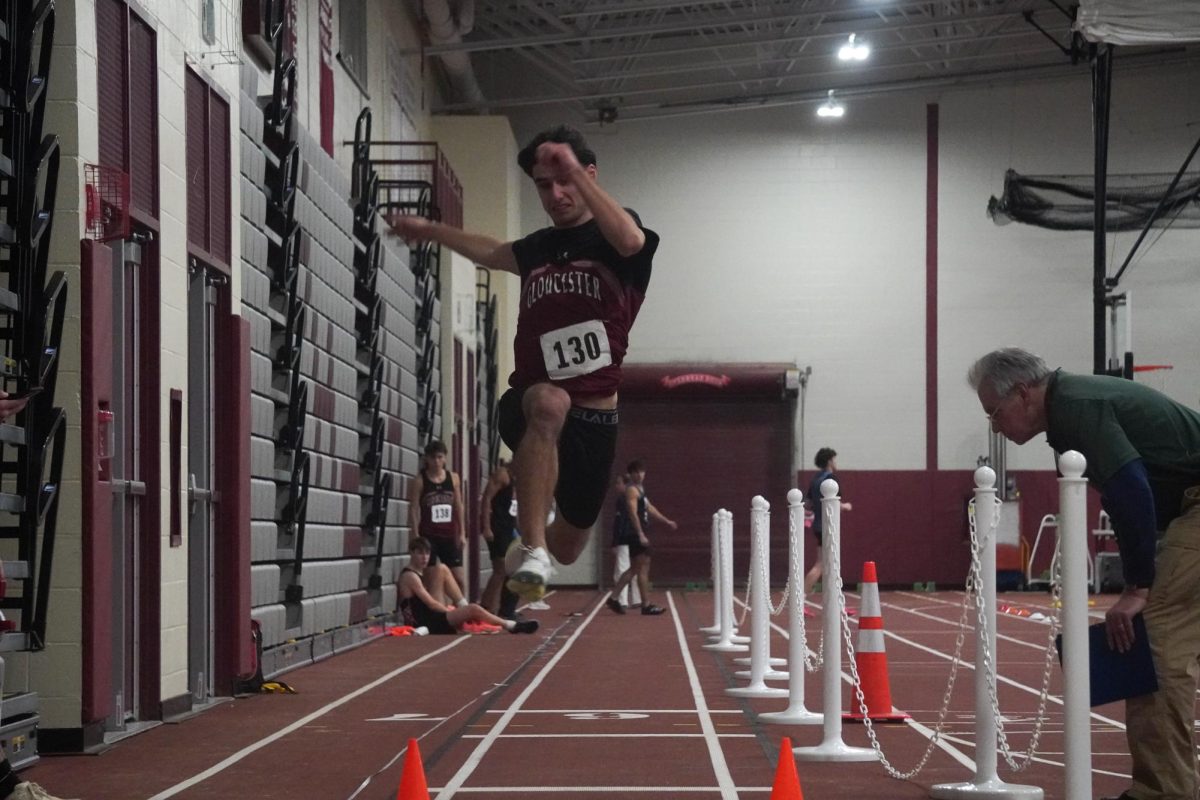 Leo Consentino jumps into the pit during men's long jump.