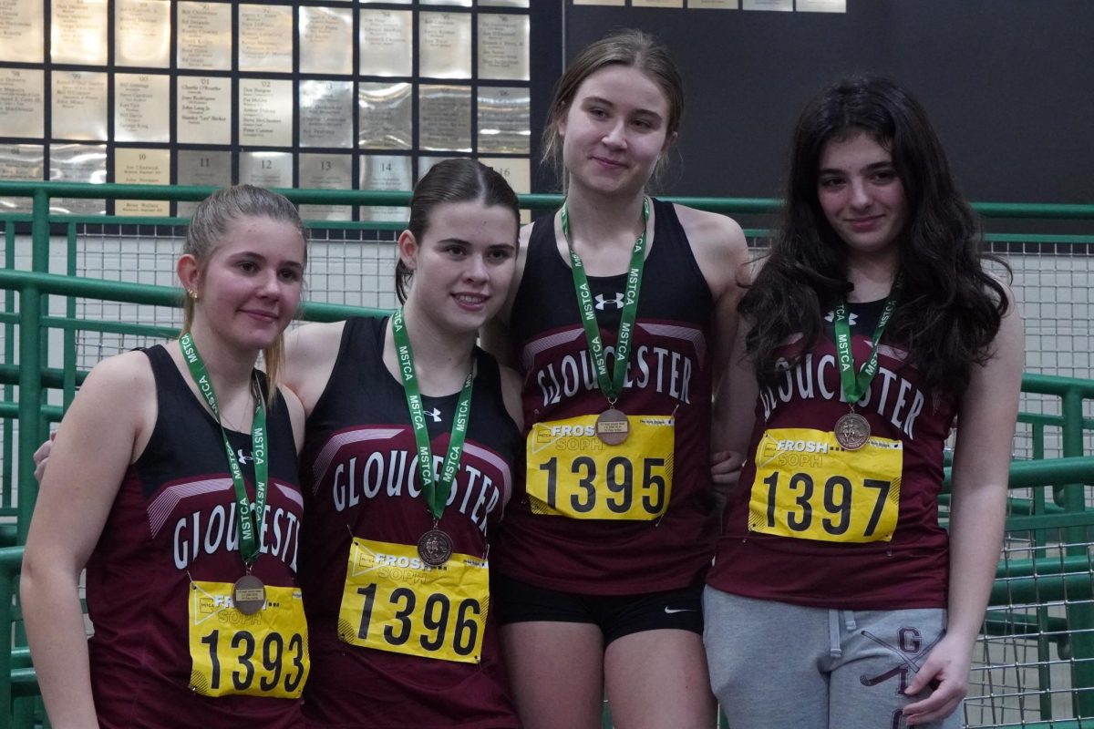 (Left to Right) Meadow Anderson, Caitlin Dewan, Grace Castellucci, and Maddie Goodhue stand on the podium after placing 7th in the 4x200 girls' relay.