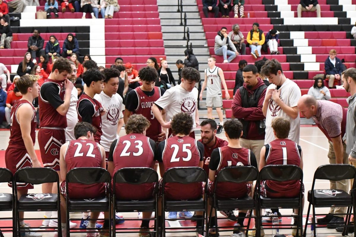 Coach Adam Phillpot talks to his team before tipoff. 