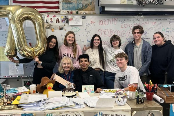 Madame Finacey’s poses with her French class during her birthday celebration.