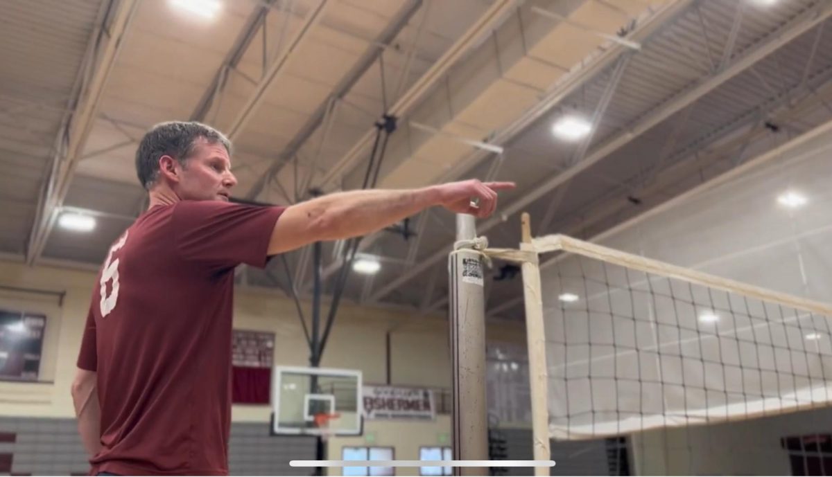 GHS history teacher Phil Cook referees an Intramural Volleyball match