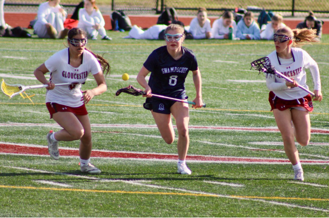 Natasha DePaula and Meadow Anderson chase after a ground ball in the Fishermen's game against Swampscott.